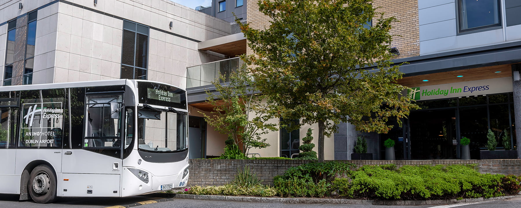 Shuttle Bus in front of the Holiday Inn Express Entrance